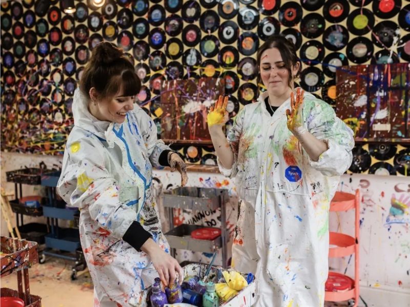 Splasherist Bath studio at 12 Widcombe Parade in Bath, two people enjoying a rage painting workshop with splashes of paint on canvas